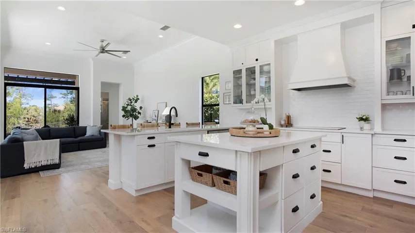 Kitchen with custom exhaust hood, light countertops, ceiling fan, healthy amount of natural light, and recessed lighting