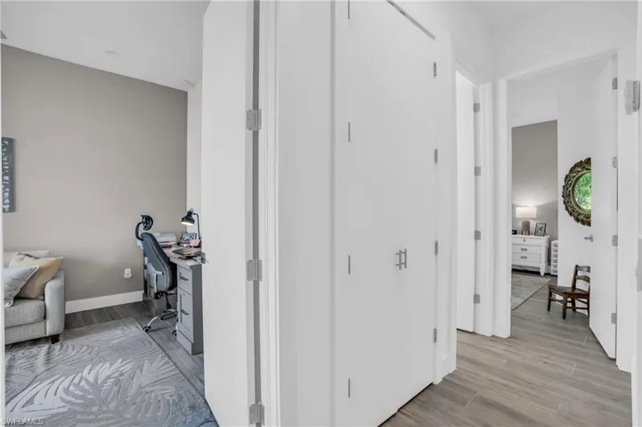 Corridor with light hardwood / wood-style floors