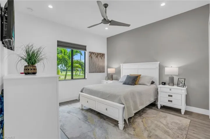 Bedroom featuring ceiling fan and wood-type flooring