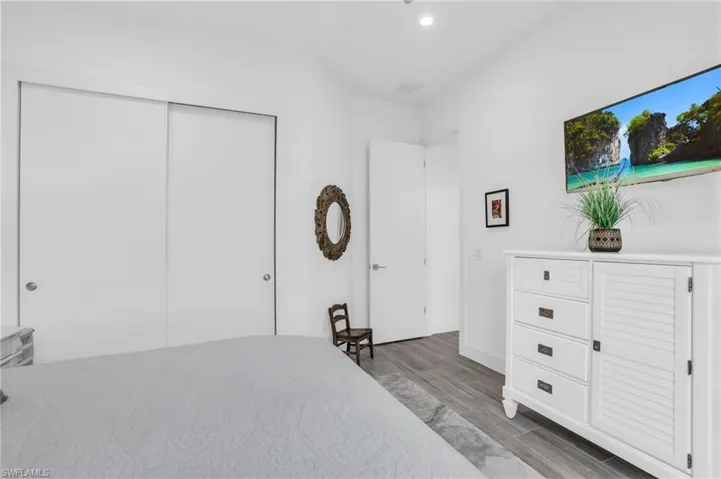 Bedroom with a closet and dark hardwood / wood-style flooring