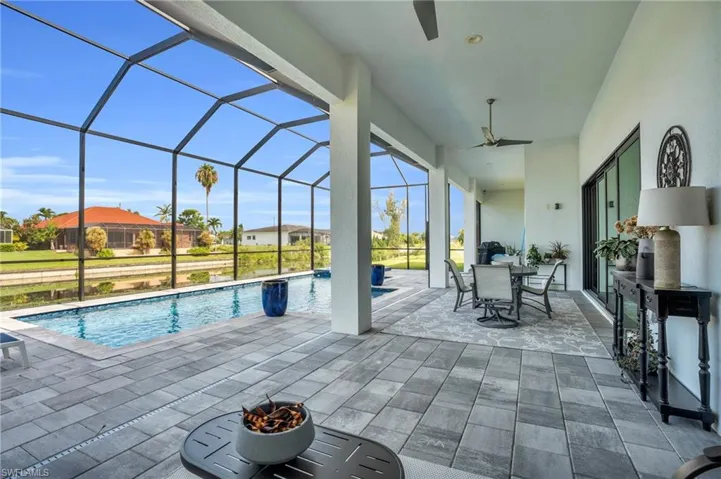 View of pool featuring a patio, a lanai, and ceiling fan