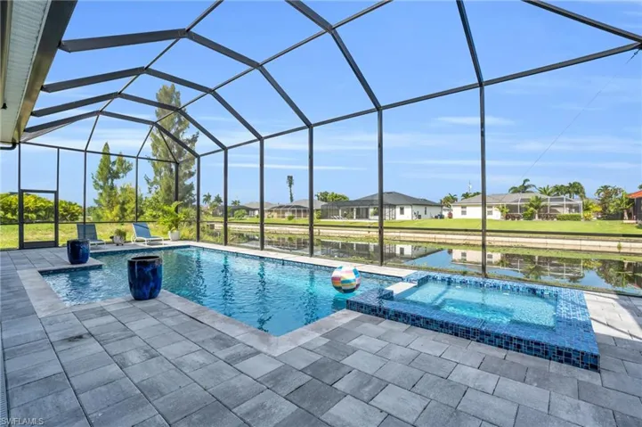 View of pool featuring a lanai, an in ground hot tub, and a patio area