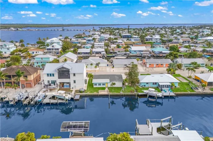 Aerial shot capturing the home’s prime waterfront location and direct canal access.