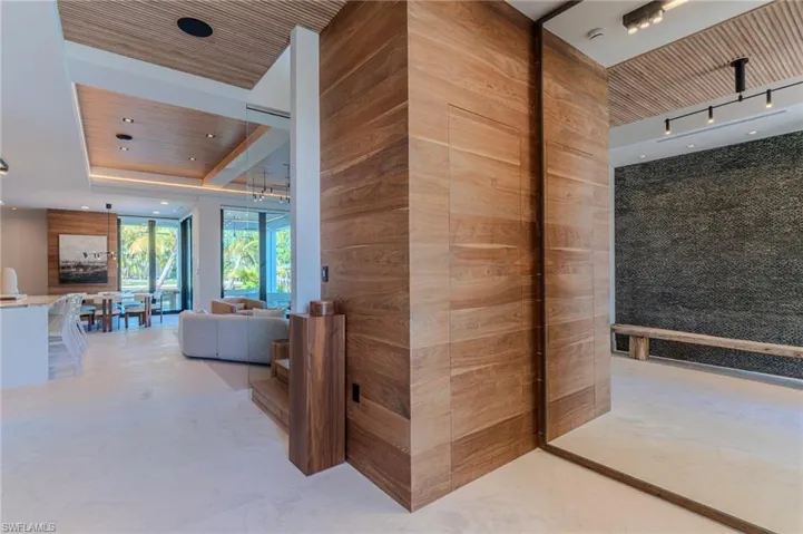 Hall with hidden hinge closet, wood ceiling and recessed lighting