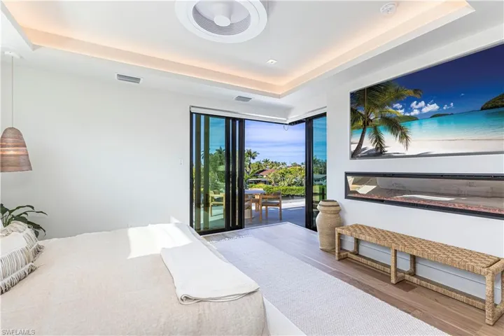 Oversized 75 inch built in tv with fireplace and sliders to rooftop sunset terrace
