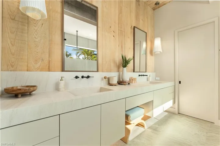 Custom travertine sinks and wood walls