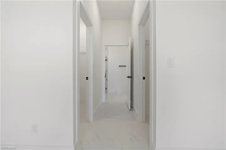Hallway featuring marble finish floor