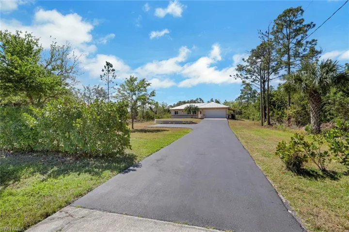 View of front of home with a front lawn and driveway