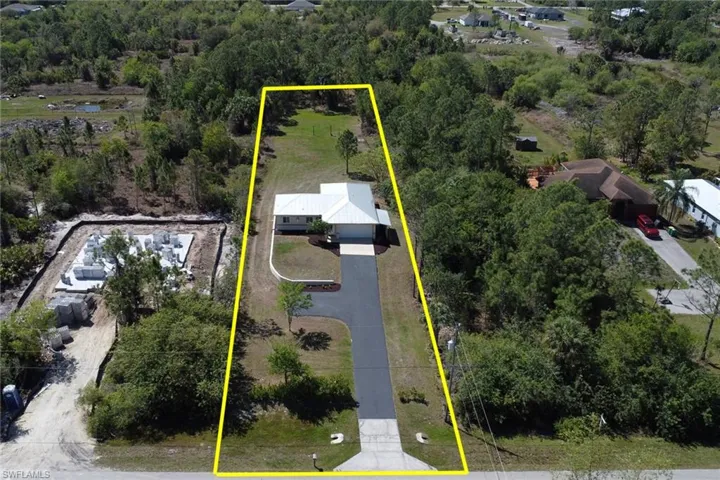 Aerial view of property and surrounding area featuring property boundaries highlighted
