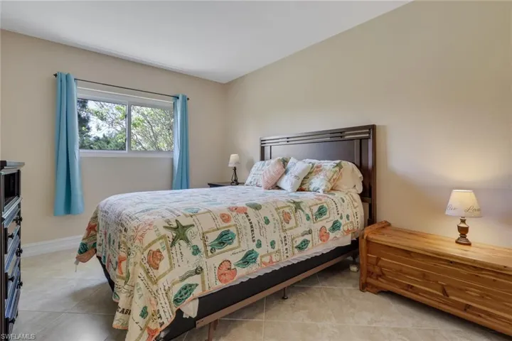 Bedroom with light tile patterned flooring