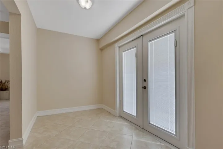 Doorway to outside with french doors and tile patterned floors