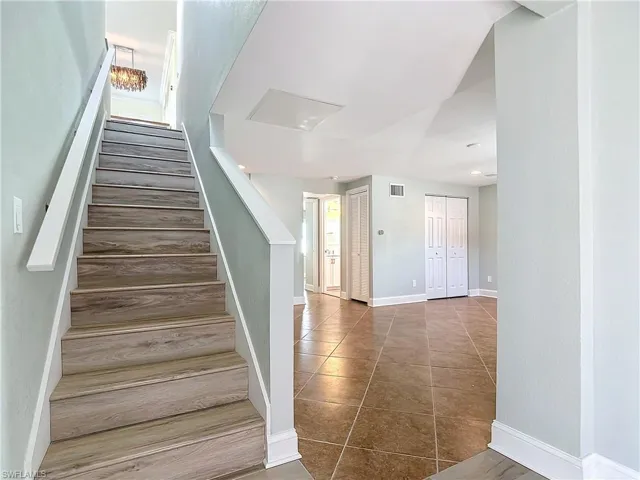 Staircase to downstairs living, bedrooms, bathroom and garage.