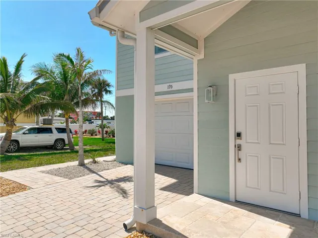 View of exterior entry with a garage