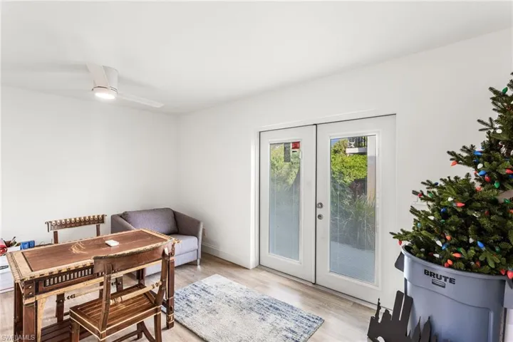 Dining area with french doors, light wood-style flooring, and a ceiling fan
