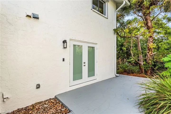 Property entrance featuring a patio area, french doors, and stucco siding