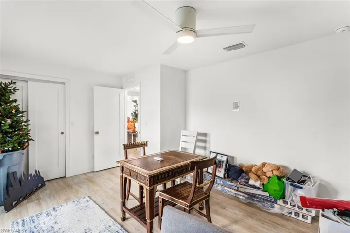 Dining space with light wood-style flooring and a ceiling fan
