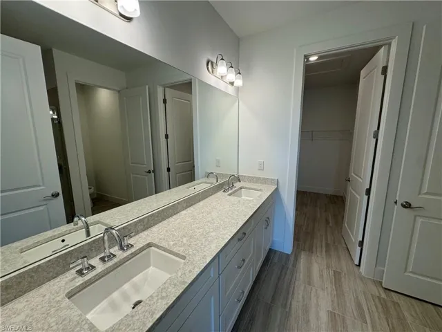 Gorgeous primary bathroom with dual-sinks, spacious walk-in shower and closet
