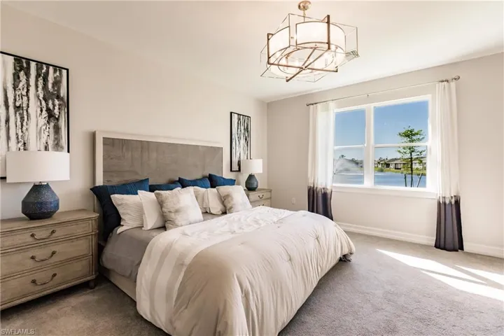 Carpeted bedroom featuring a chandelier