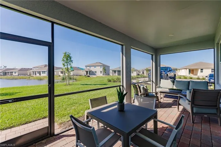 Sunroom / solarium featuring a water view