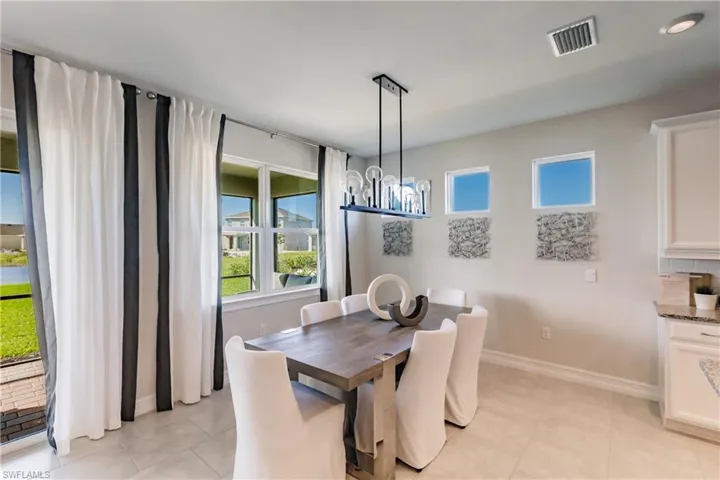Tiled dining space with a chandelier
