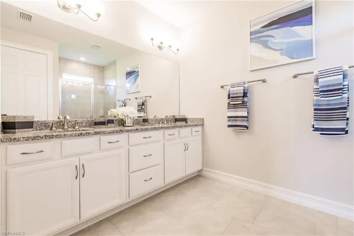 Bathroom with tile patterned flooring and double sink vanity