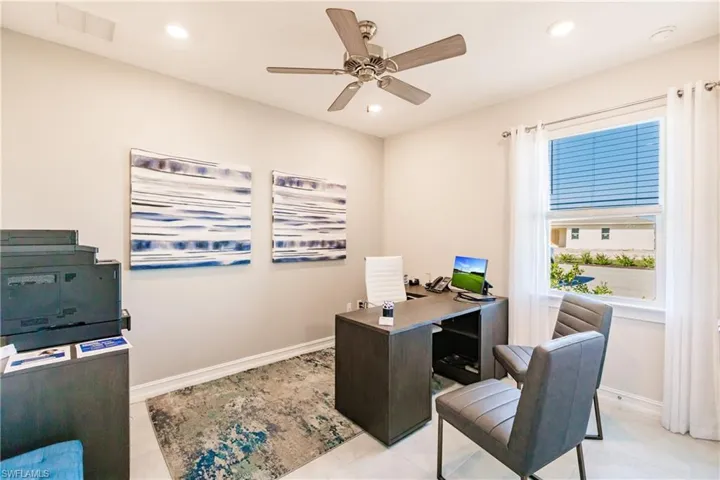 Office with ceiling fan and light tile patterned floors