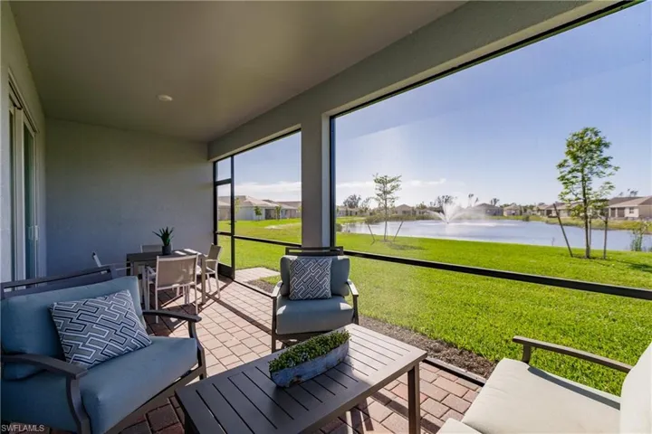 Sunroom featuring a water view