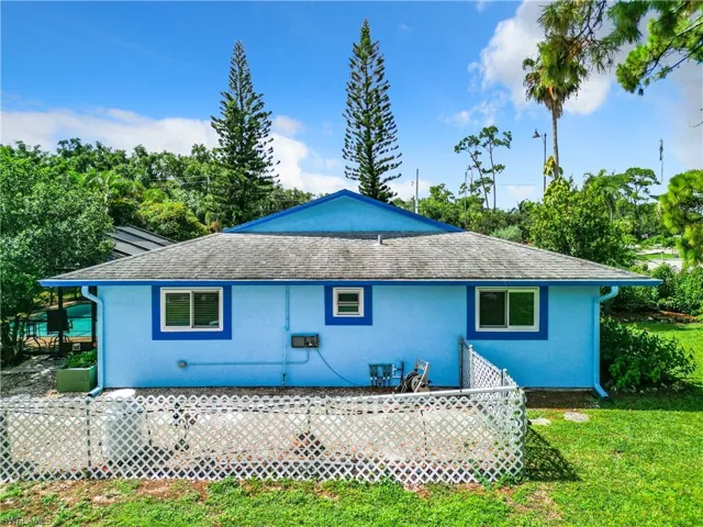 Back of property with a yard