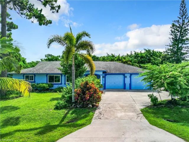 Ranch-style home with a garage and a front yard