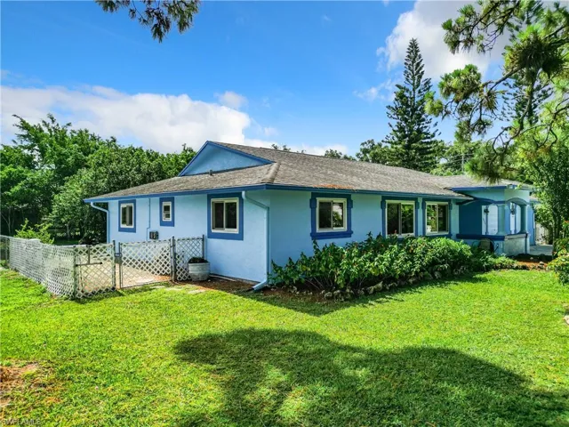Rear view of house with a yard