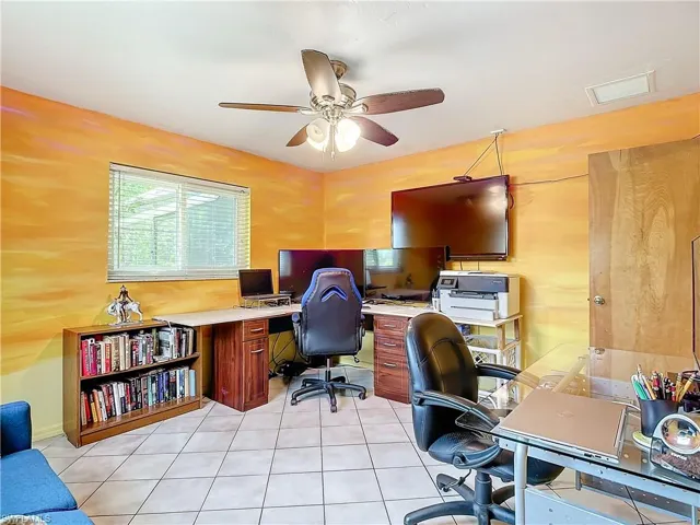 Office space with light tile patterned flooring and ceiling fan