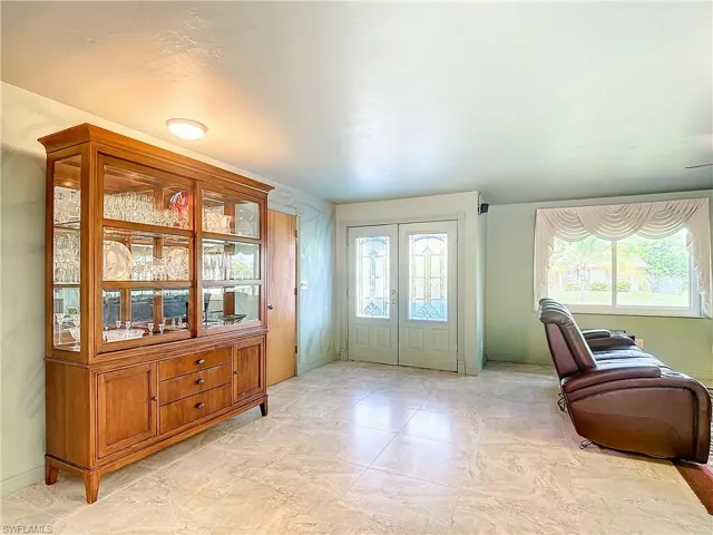 Foyer featuring french doors and light tile patterned floors