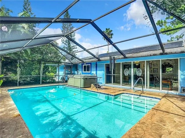 View of pool featuring glass enclosure