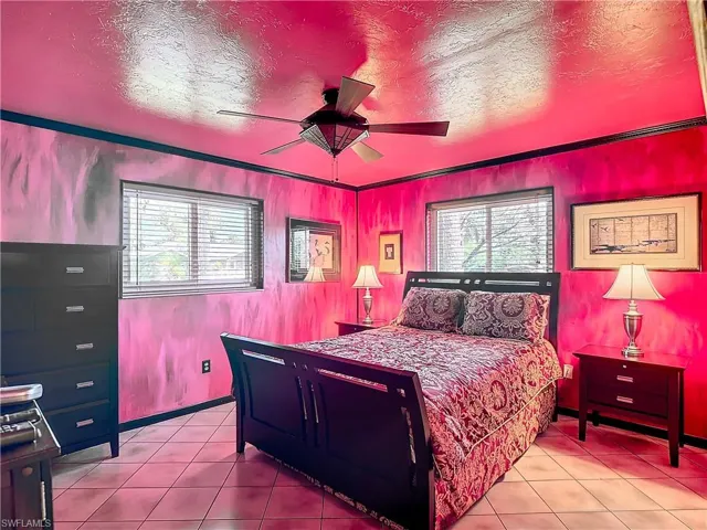 Bedroom with light tile patterned floors and ceiling fan