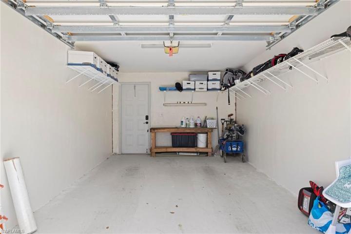 Garage with auto door and extra storage shelves
