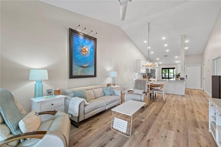 Great room with vaulted ceilings and luxury vinyl plan flooring