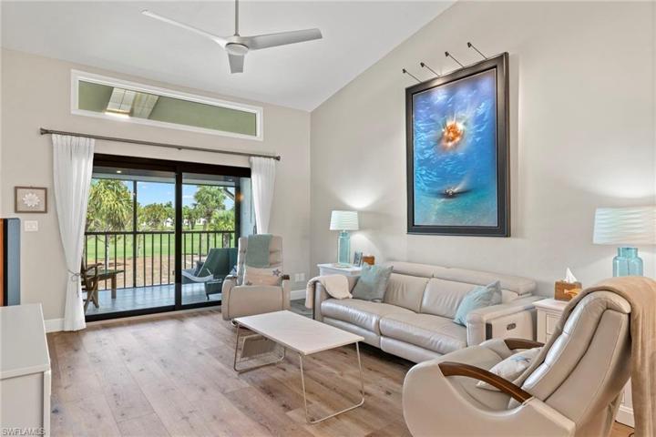Living area with impact glass sliders to golf course side lanai