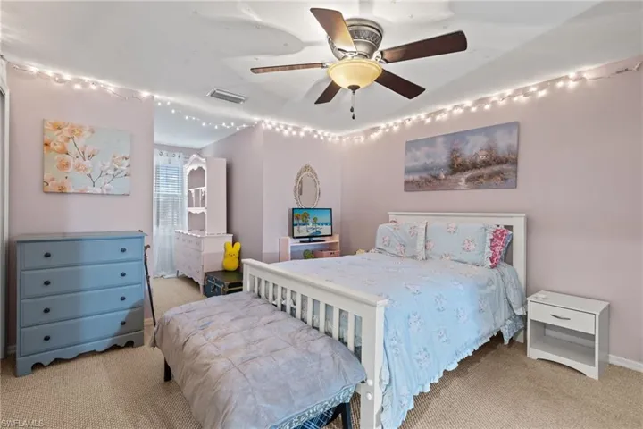 Carpeted bedroom with ceiling fan