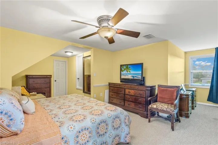 Bedroom featuring ceiling fan and carpet flooring