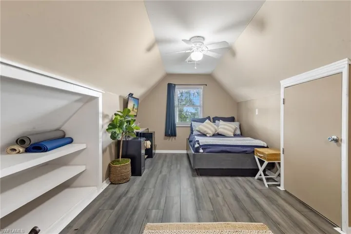 Bedroom with ceiling fan, vaulted ceiling, and hardwood / wood-style flooring
