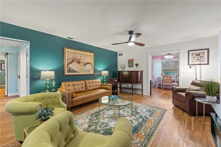 Living room with hardwood / wood-style floors and ceiling fan