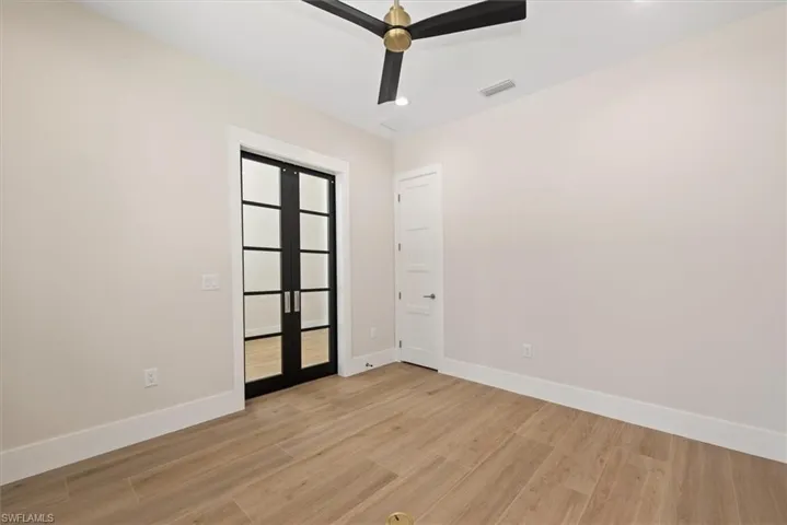Spare room with light wood-style flooring, recessed lighting, ceiling fan, and french doors