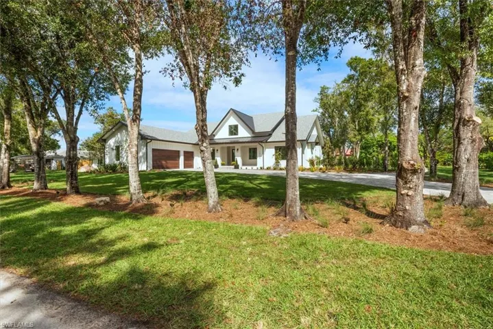 Modern inspired farmhouse featuring a front yard and a porch