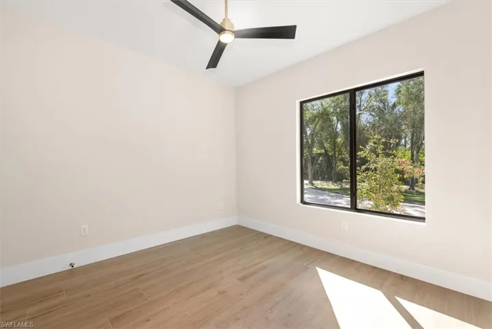 Empty room featuring light wood-type flooring and ceiling fan