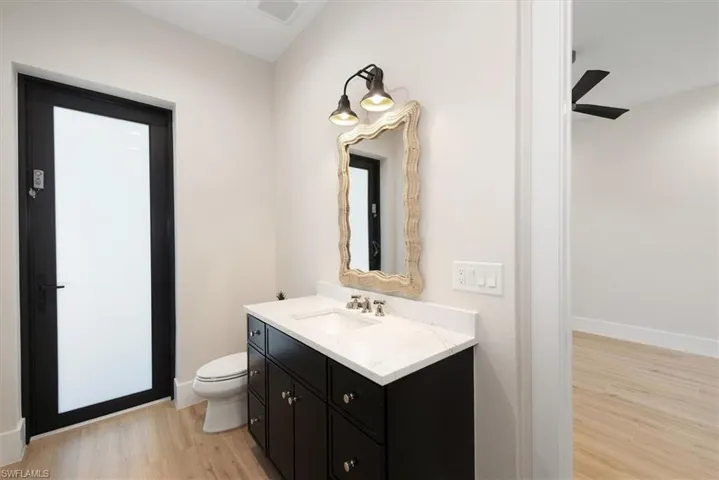 Bathroom with light wood-style floors and vanity
