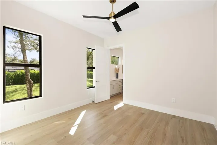 Empty room with light wood-style floors and ceiling fan