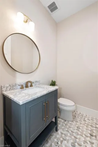 Bathroom with vanity and baseboards