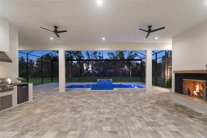 View of pool with a patio area, ceiling fan, and a sunroom