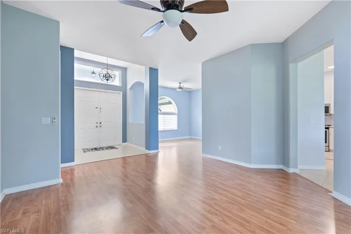 Foyer entry featuring double doors, a transom window, and an overhead light fixture