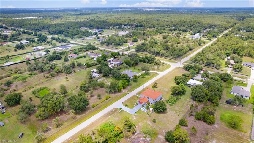 Expansive residential land parcel featuring a mix of cleared areas and mature trees, offering varied terrain